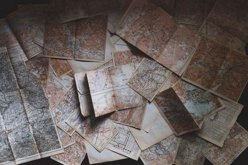 Travel Light - maps lying on the floor