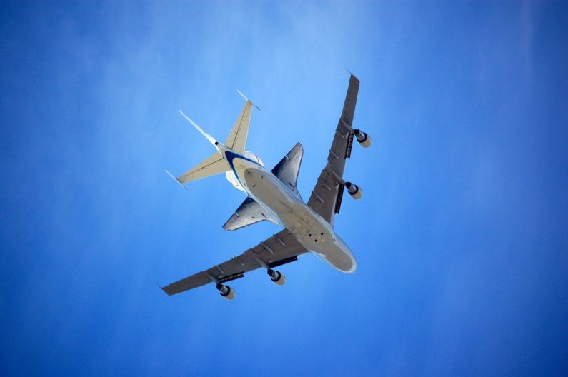 Jet Lag - low angle photography of white plane on sky