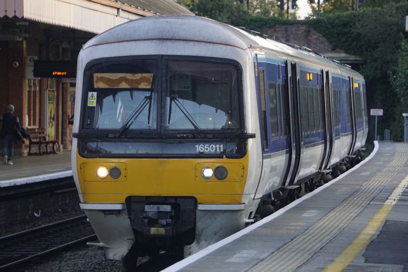 Travel Accommodation - a yellow and white train pulling into a train station