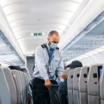 Airport Hacks - man in blue dress shirt standing in airplane