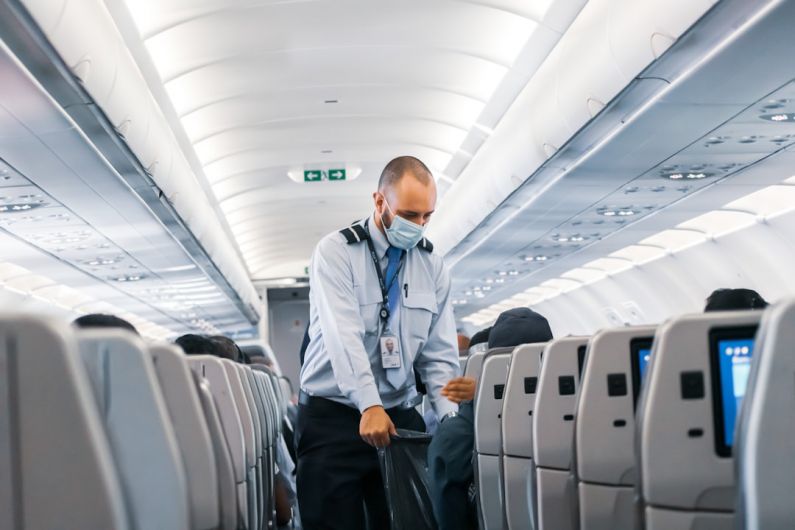 Airport Hacks - man in blue dress shirt standing in airplane