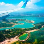 Bali Island - person inside airplane flying at high altitude with view of island during daytime