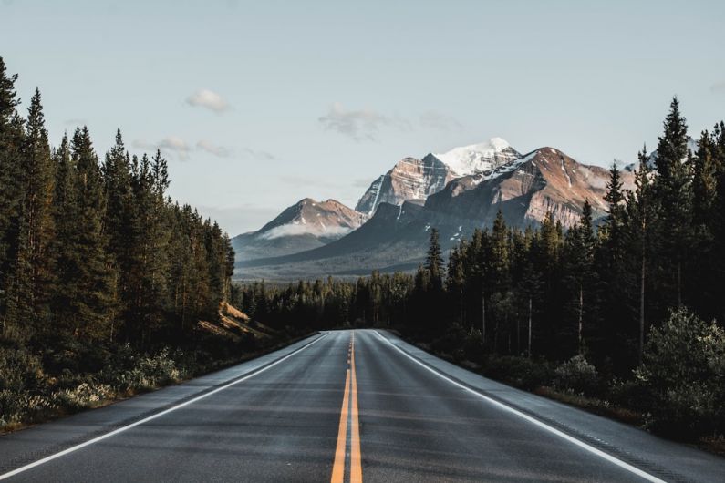 Canadian Rockies - wide road under blue sky