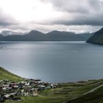 Undiscovered Islands - calm body of water and mountain