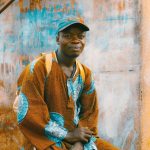 Africa Cultural - man sitting on chair near wall