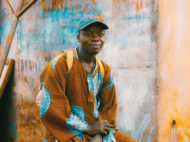 Africa Cultural - man sitting on chair near wall