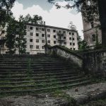 Ghost Towns - gray concrete building near green trees during daytime