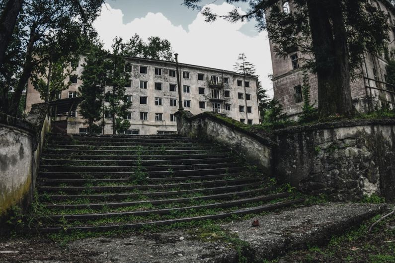 Ghost Towns - gray concrete building near green trees during daytime