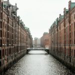 Amazon City - body of water between brown concrete buildings during daytime