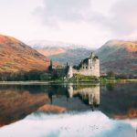 Scottish Highlands - gray concrete building near lake under white sky during daytime