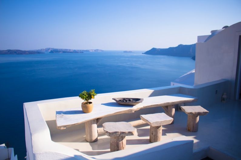 Hostel Europe - bench and dining table near body of water under calm sky