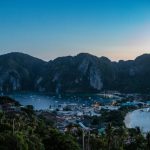 Island Getaway - a view of a bay with boats and mountains in the background