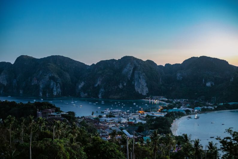 Island Getaway - a view of a bay with boats and mountains in the background