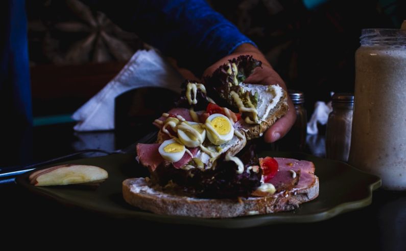 Culinary Budget - person holding piece of cake