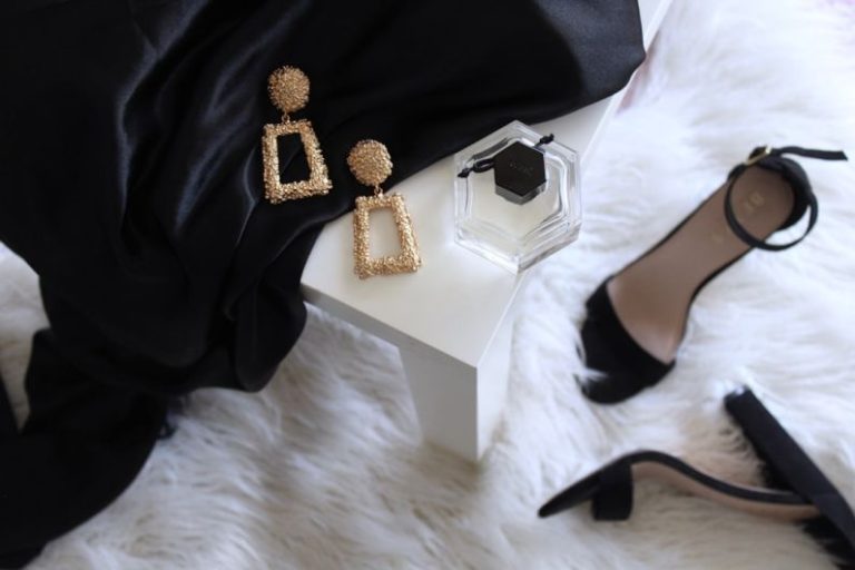 Luxury Spots Budget - pair of gold-colored earrings on table and black ankle-strap pumps on area rug