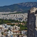 Tourist Traps - a group of people standing on top of a tall building