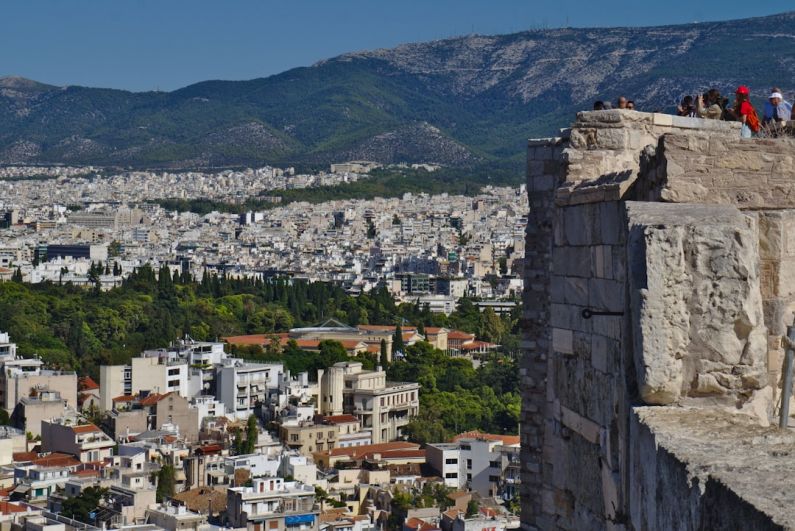 Tourist Traps - a group of people standing on top of a tall building